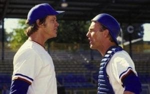 Two baseball players are talking to each other.