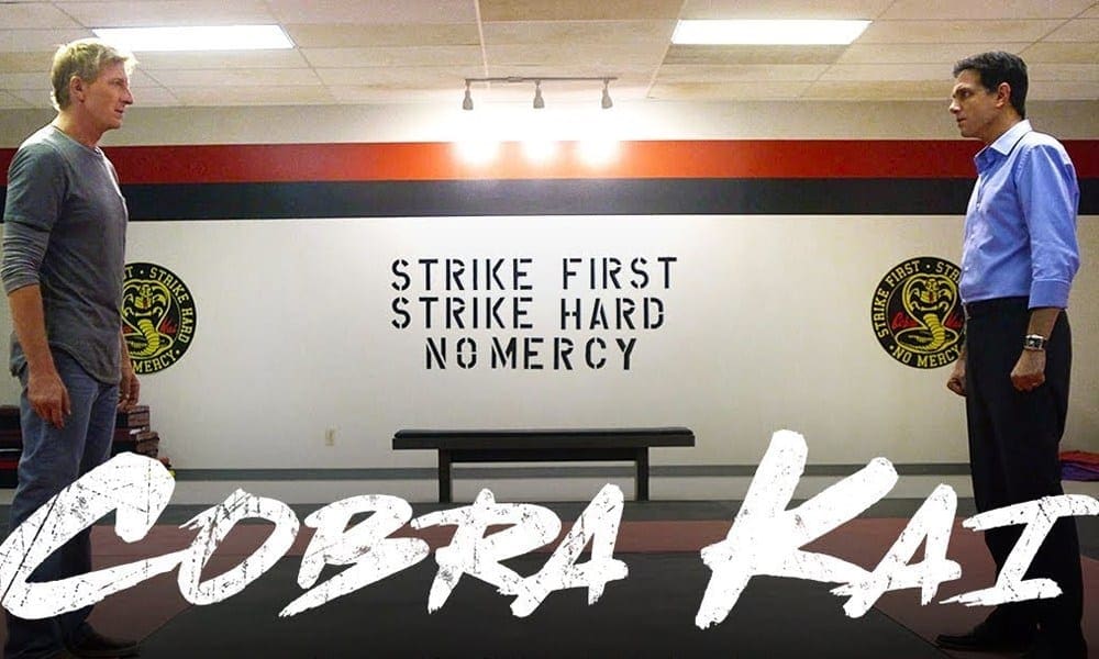 A bench in front of a wall with the words " cobra kai " written on it.