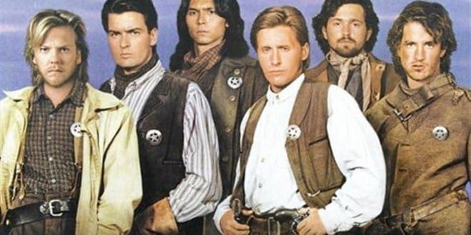 A group of men in old time clothing holding guns.