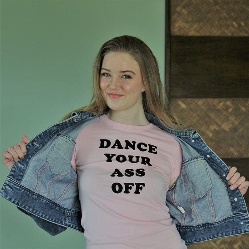 A girl is posing for the camera wearing a jean jacket.