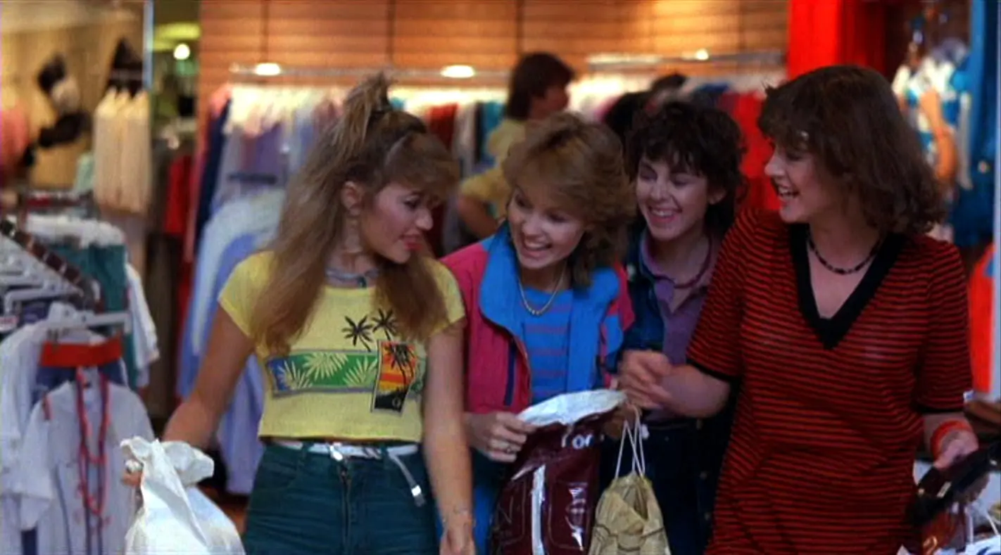 Three women are standing together in a store.