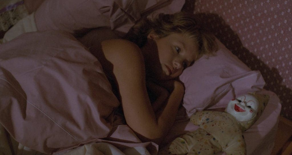 A woman laying in bed with her head on the pillow.