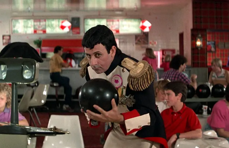 A man in uniform holding a bowling ball.