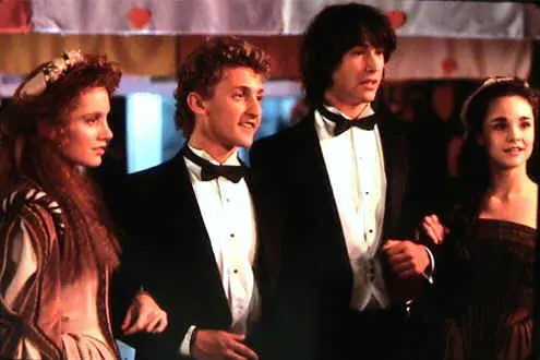 A group of people in tuxedos standing next to each other.