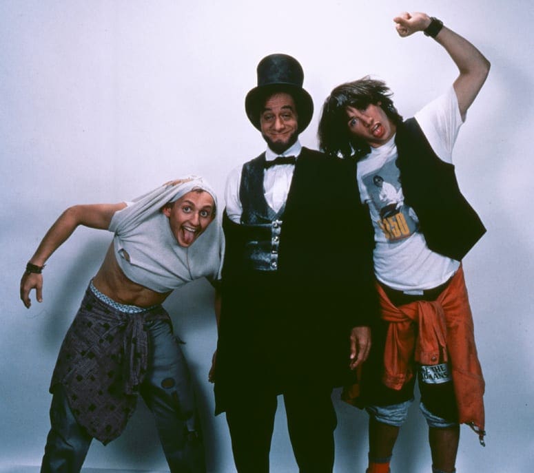 Three people dressed up in costumes posing for a picture.