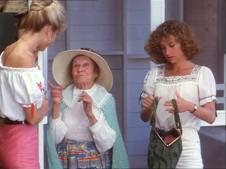 Three women standing outside talking to each other.