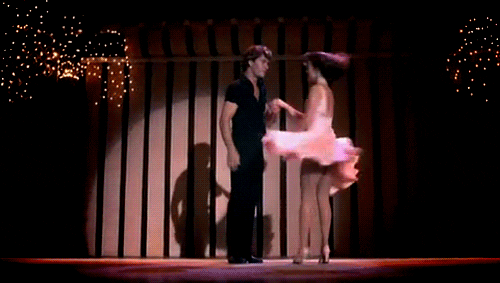 A man and woman dancing on stage.