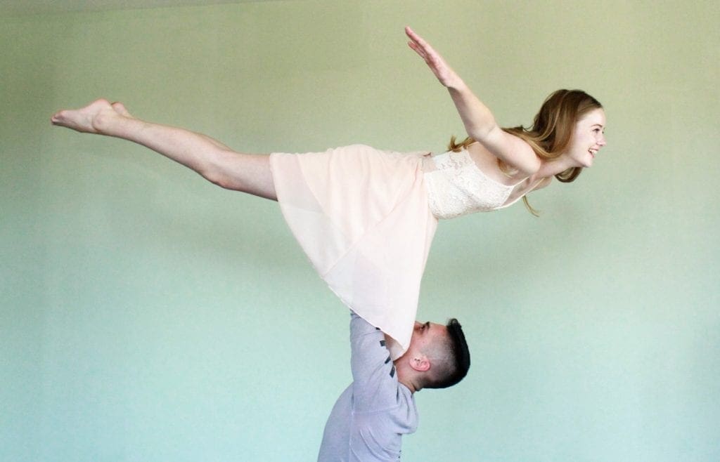 A man and woman are performing an aerial dance.