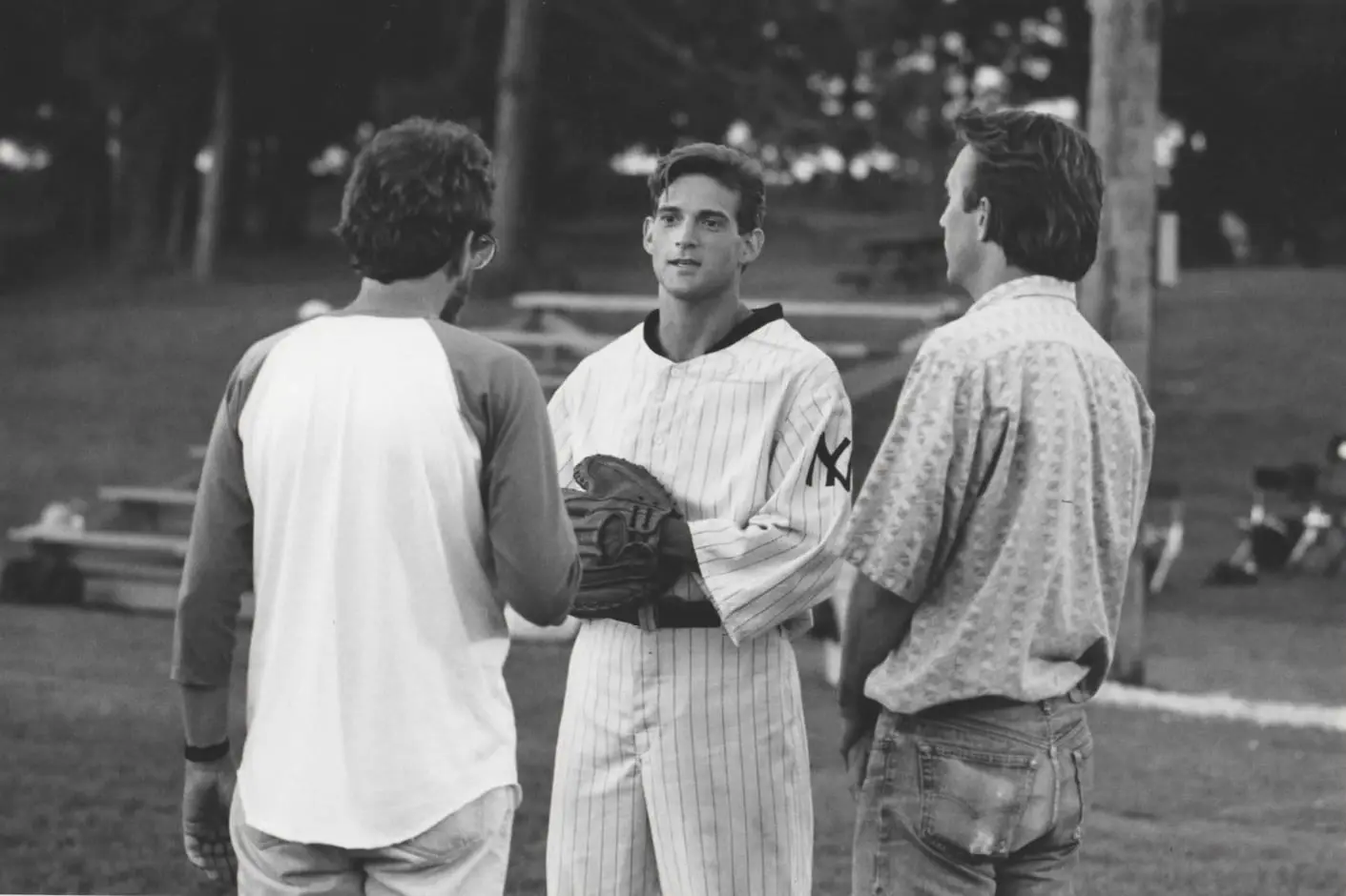 A group of men standing around each other.