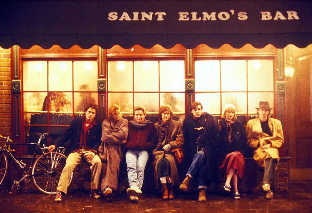 A group of people sitting on top of a bench.