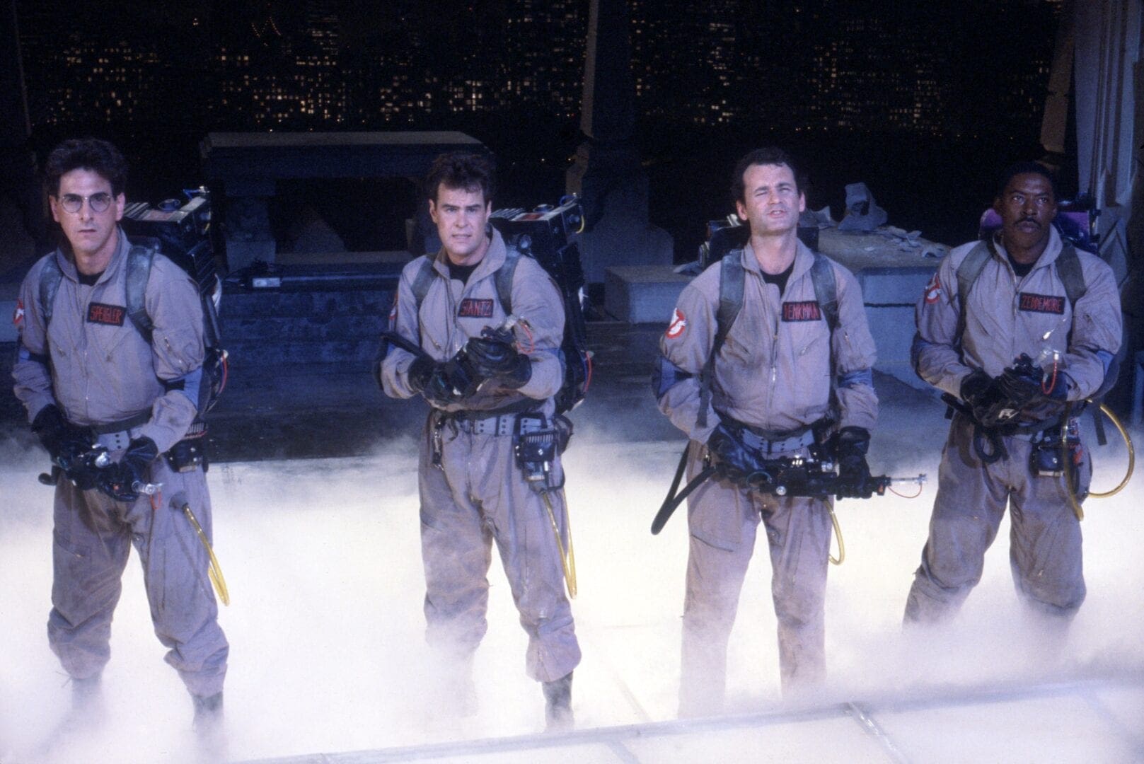 A group of men in grey suits standing on top of a platform.