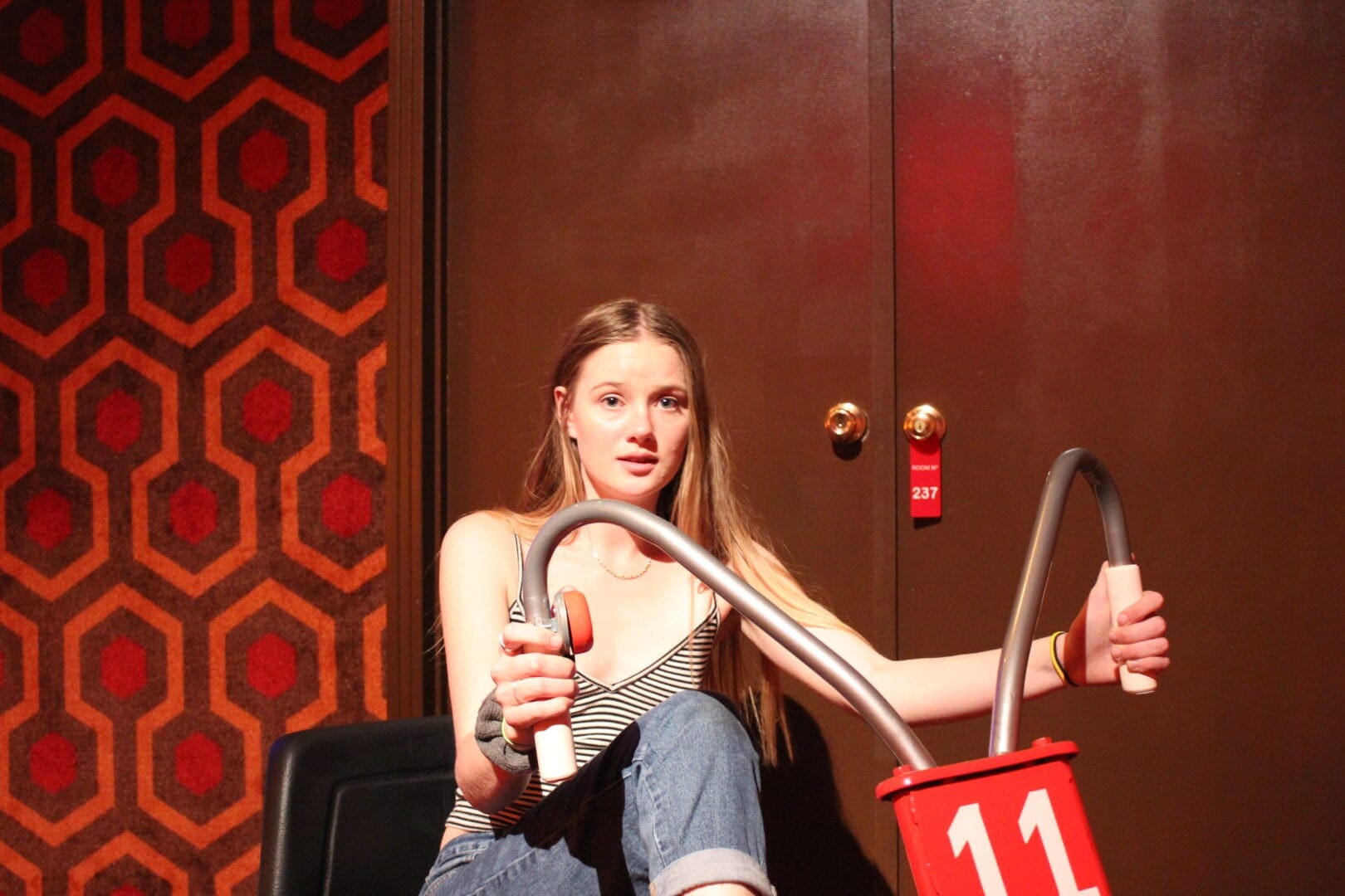 A girl sitting on the floor holding a bottle