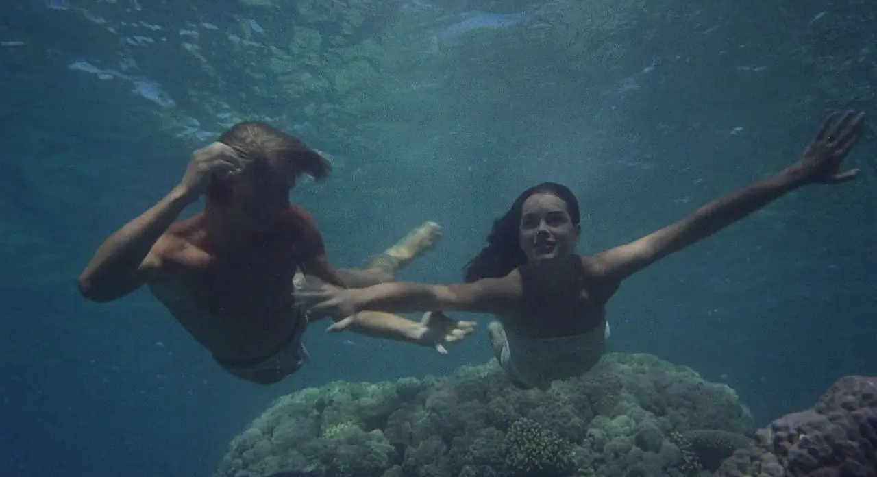 A woman and child swimming in the ocean.