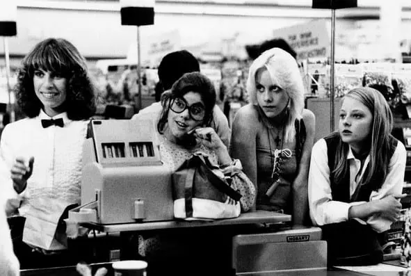 A group of people sitting at tables with drinks.