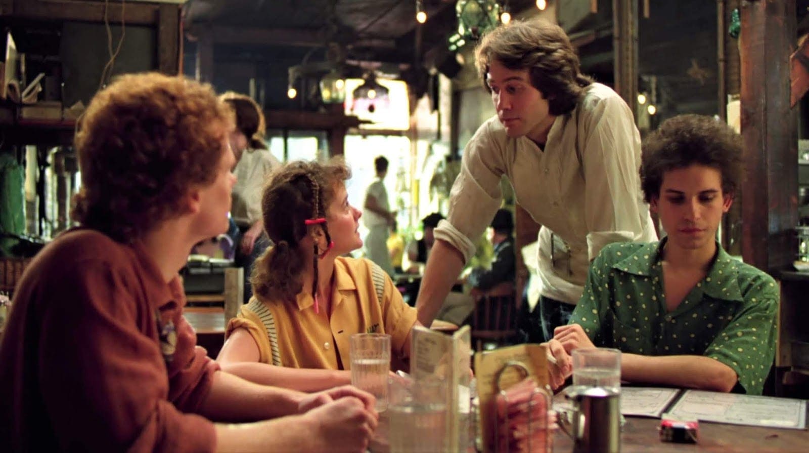 A group of people sitting at tables in a restaurant.