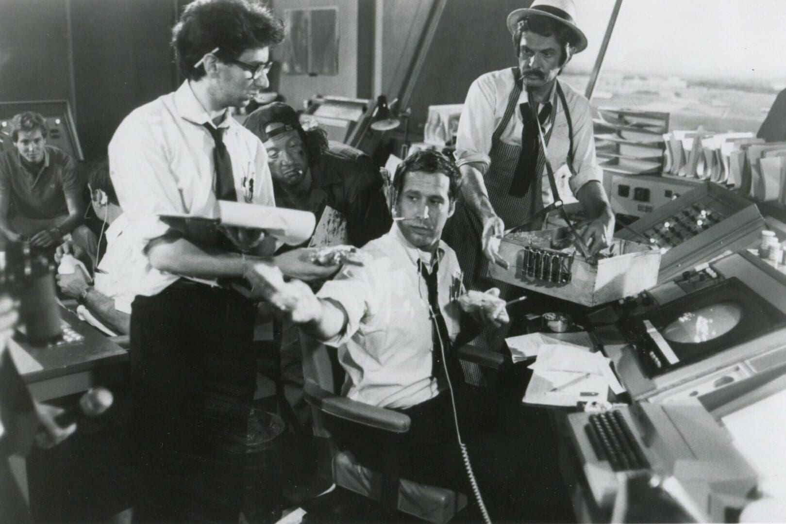 A group of men sitting at a desk.